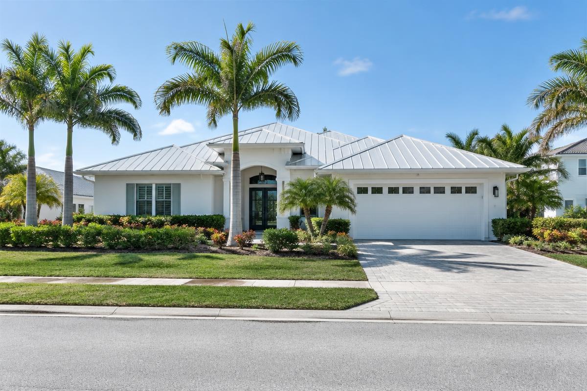 Illustrative coastal-style Florida home with a metal roof and palms